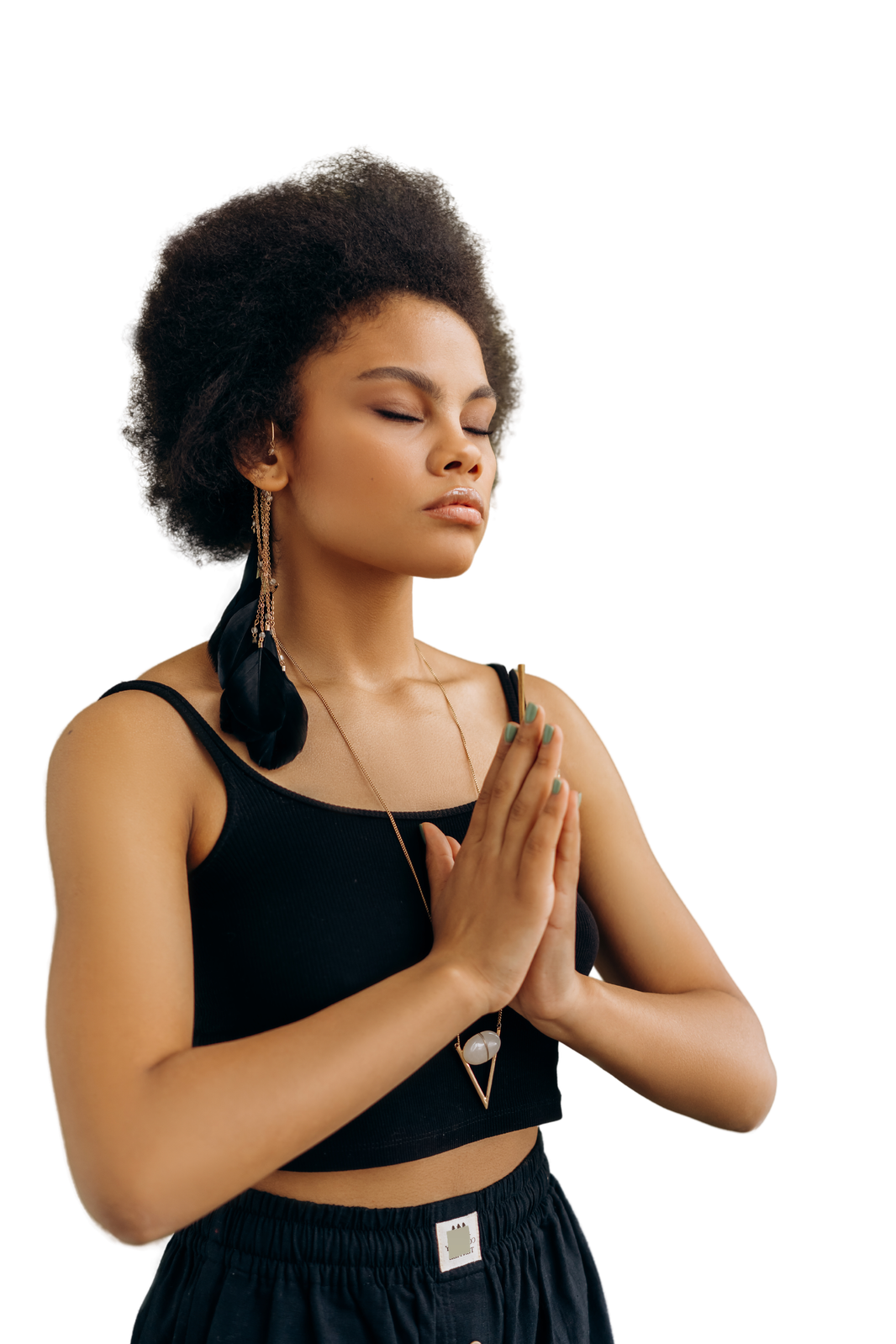 Black woman pausing with her hands together in a quiet grounding moment.